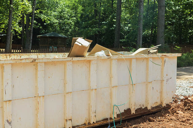A rubbish removal metal container is used for trash disposal at a White Plains, NY, construction site.