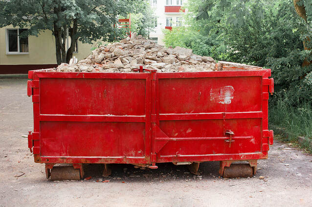 A red container in White Plains, NY, contains solid domestic and construction waste.